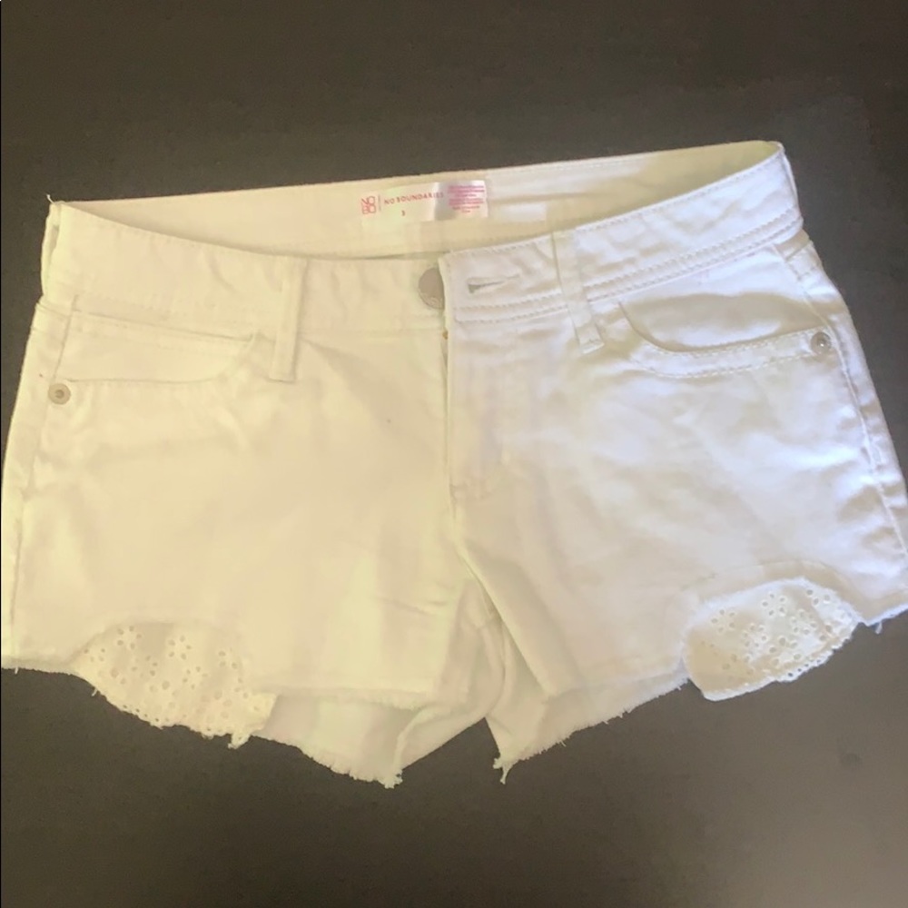White cut off jean shorts with lace pockets